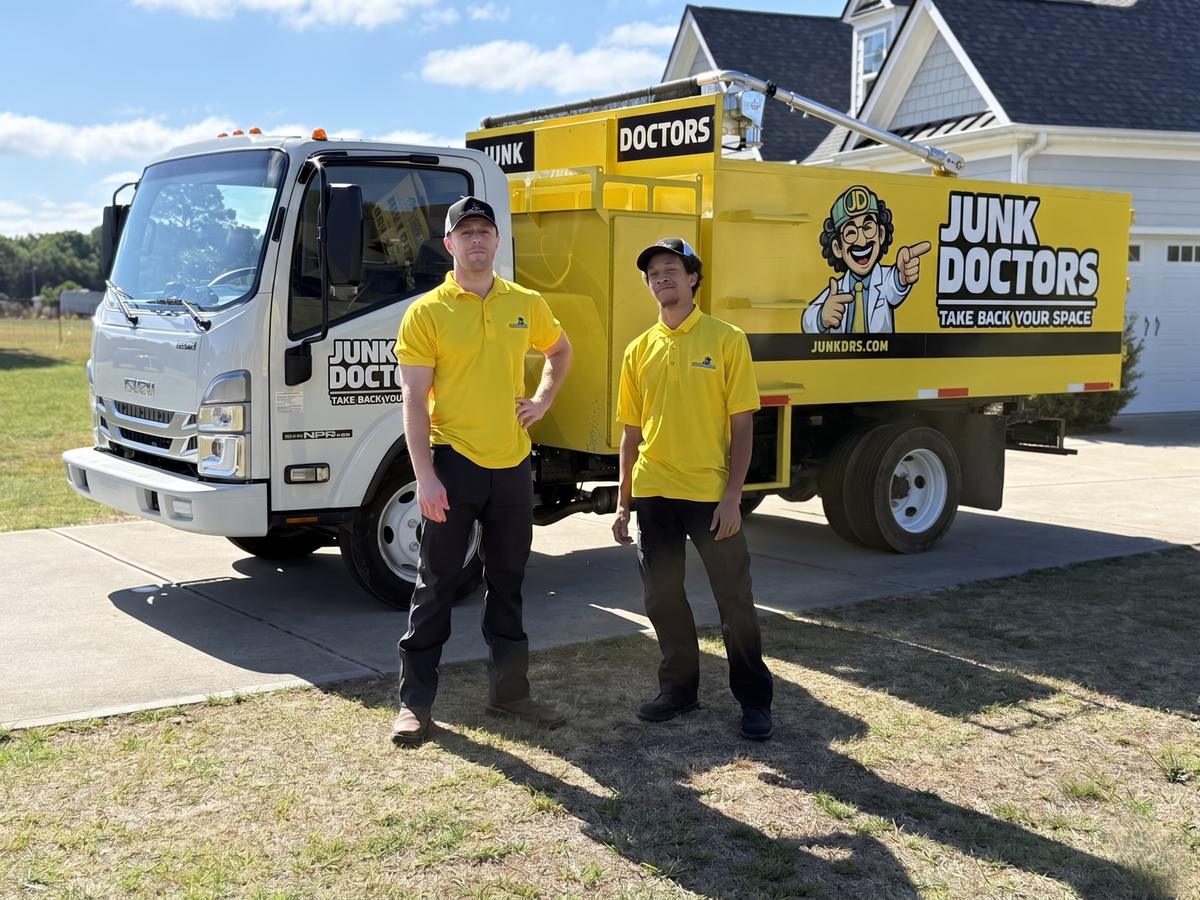 Junk Doctors crew loading a truck at a Raleigh NC home — licensed, insured, background-checked