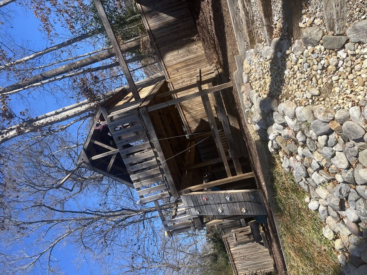 Old rotting playset and wooden structure in backyard — before Junk Doctors demolition